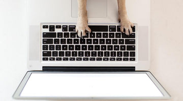 Dog paws working on laptop
